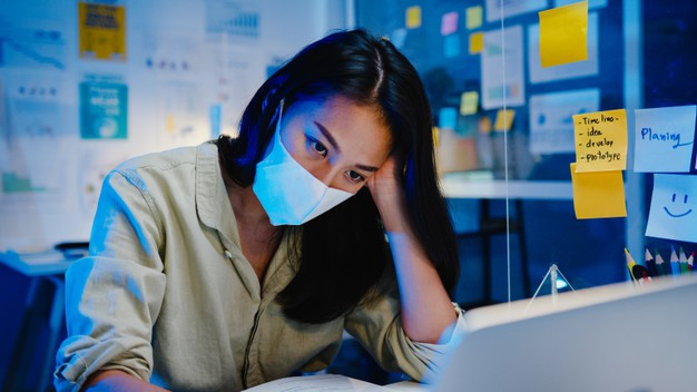 Freelance asia women wear face mask using laptop