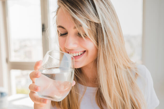 Healthy girl drinking glass of water