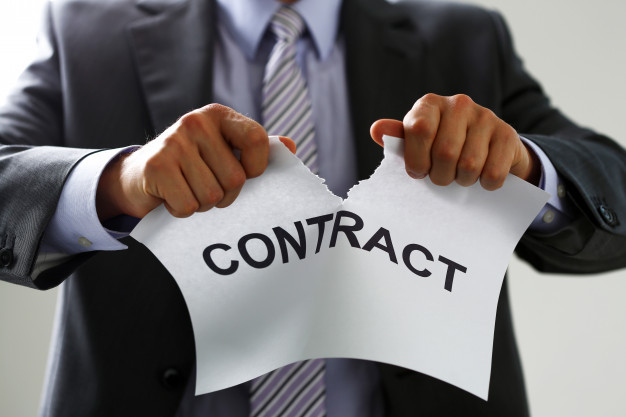 White collar worker in suit and tie tear contract