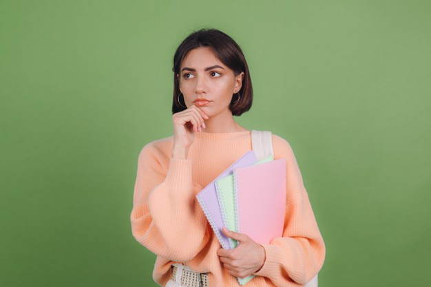 Young woman in casual peach sweater